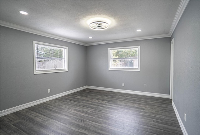 spare room featuring dark hardwood / wood-style flooring, a textured ceiling, and ornamental molding