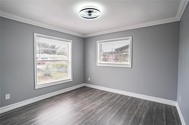 empty room with dark hardwood / wood-style floors and crown molding