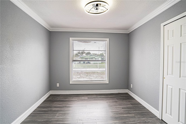 empty room featuring crown molding, dark hardwood / wood-style flooring, and a textured ceiling