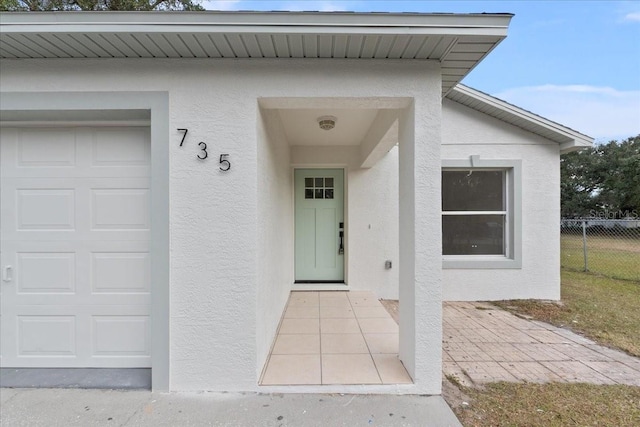 doorway to property with a garage