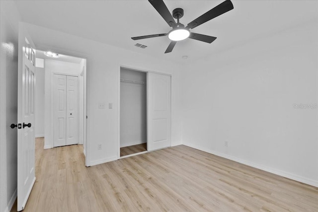 unfurnished bedroom featuring ceiling fan, a closet, and light hardwood / wood-style flooring