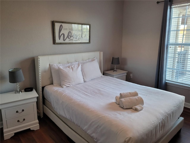 bedroom with dark wood-type flooring