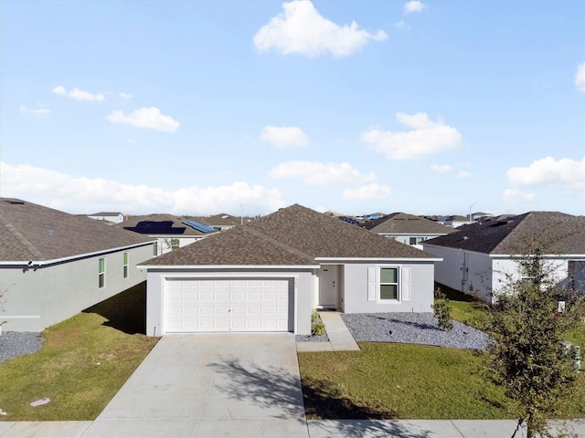 view of front of property with a front lawn and a garage