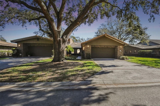 ranch-style home with a front lawn and a garage