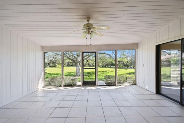 unfurnished sunroom with ceiling fan and a healthy amount of sunlight