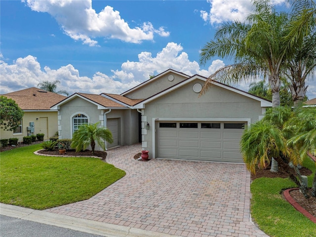 ranch-style home with a front yard and a garage