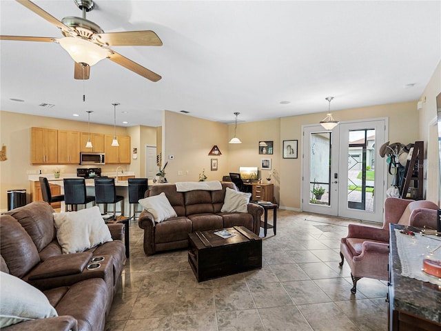 living room with ceiling fan and french doors