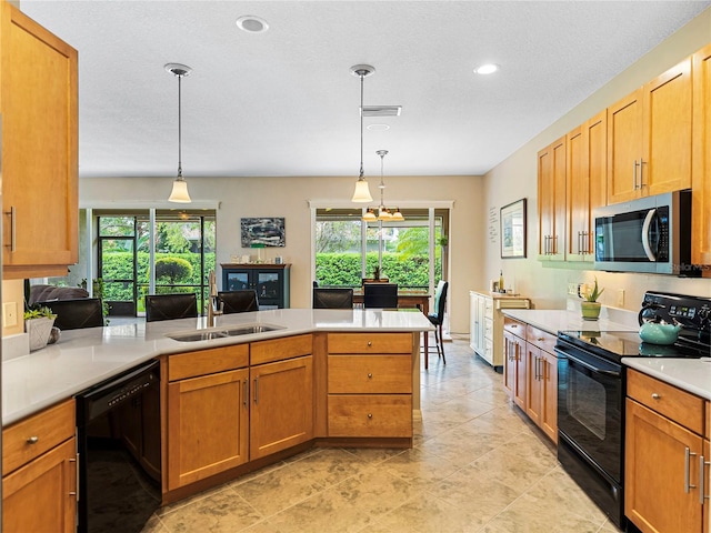 kitchen featuring a wealth of natural light, sink, hanging light fixtures, and black appliances