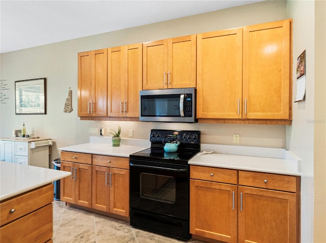 kitchen featuring black / electric stove and light tile patterned flooring