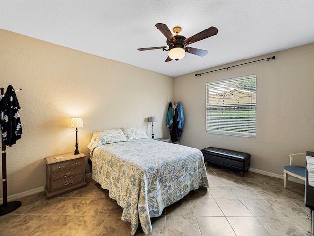 bedroom with ceiling fan and tile patterned floors