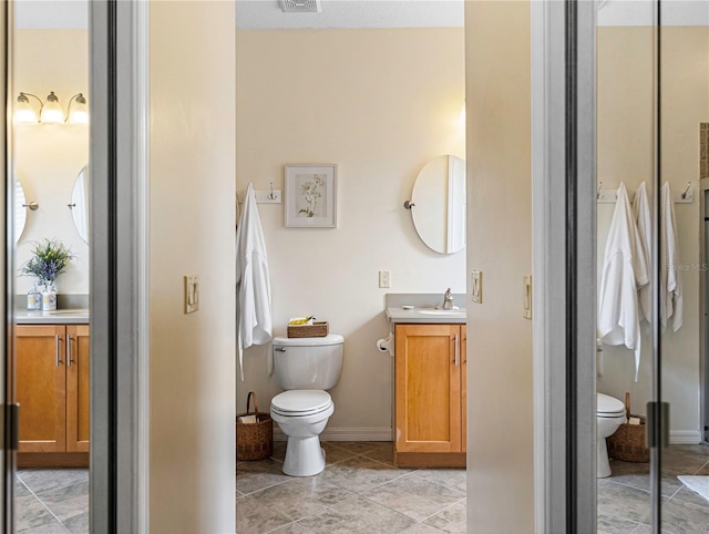 bathroom featuring toilet and vanity