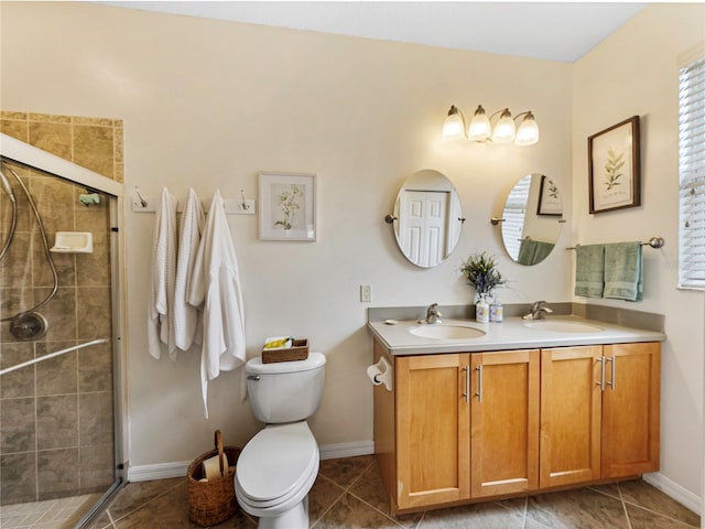 bathroom featuring toilet, tile patterned floors, walk in shower, and vanity