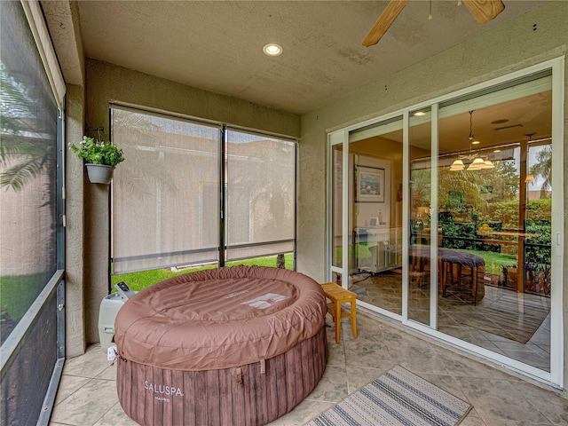 sunroom / solarium featuring ceiling fan