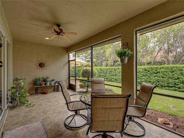 sunroom / solarium featuring ceiling fan