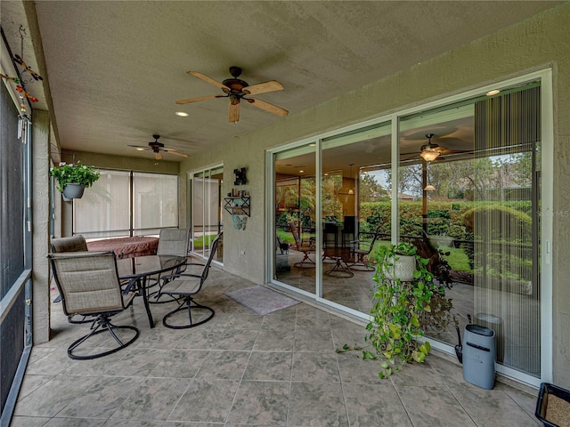 sunroom / solarium featuring ceiling fan