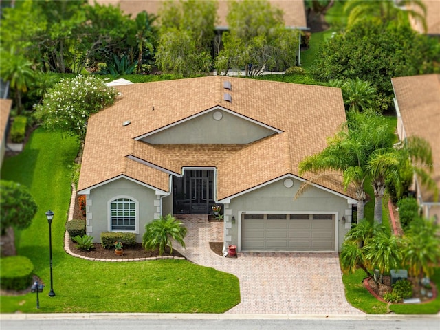 view of front of home with a front lawn and a garage