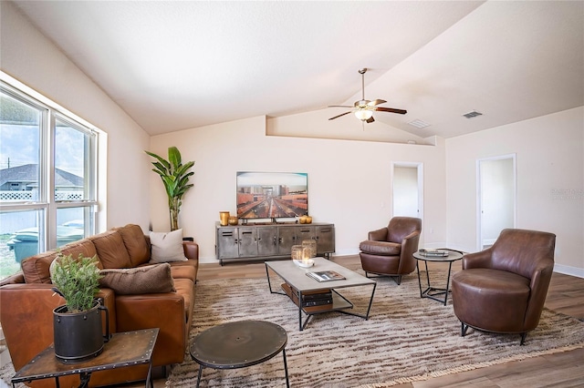 living room with ceiling fan, lofted ceiling, and wood-type flooring