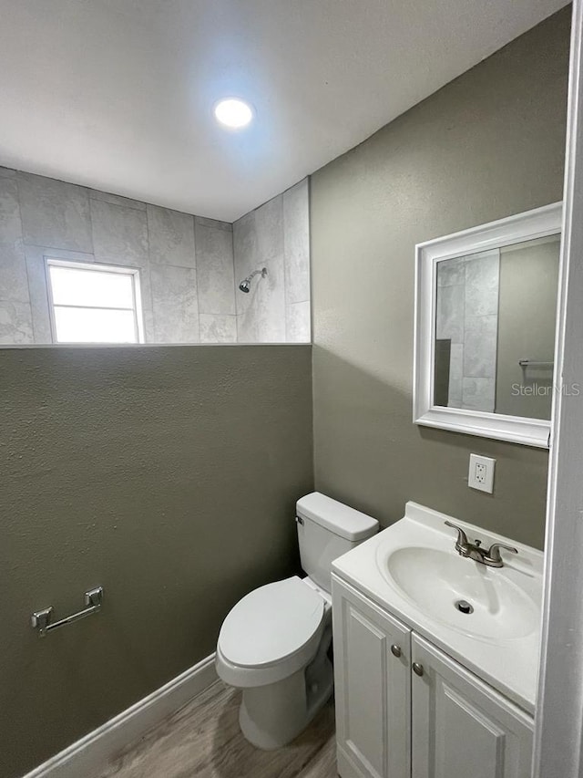 bathroom featuring hardwood / wood-style floors, vanity, and toilet