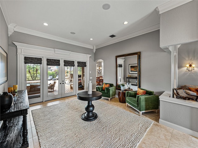 living room with light tile patterned floors, ornamental molding, french doors, and ornate columns