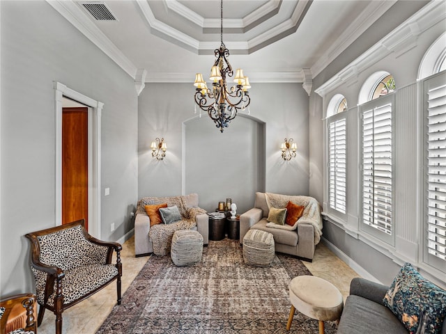 sitting room with ornamental molding, a tray ceiling, and a chandelier