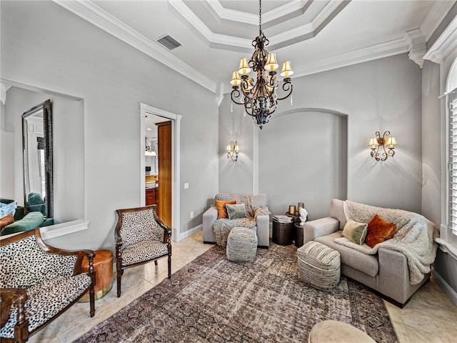 living area featuring crown molding, a tray ceiling, and a chandelier