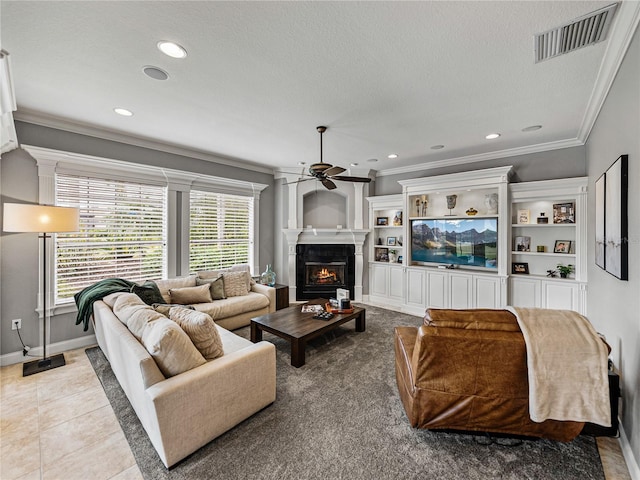 living room with crown molding, ceiling fan, a textured ceiling, and light tile patterned floors