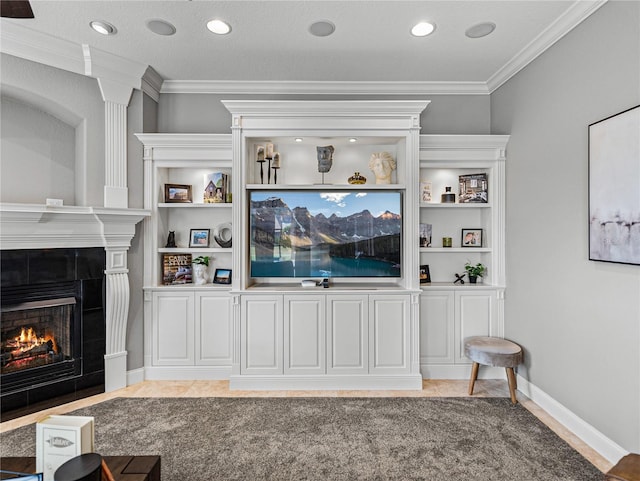 tiled living room with built in shelves, ornamental molding, and a tile fireplace