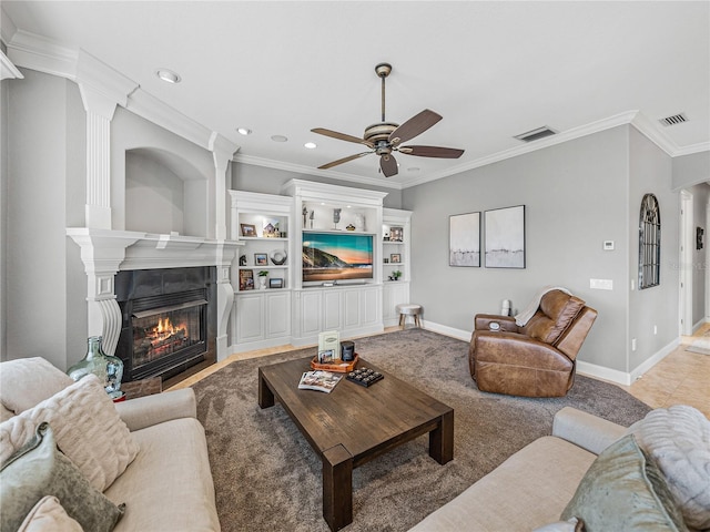 living room with ornamental molding, a tile fireplace, and ceiling fan