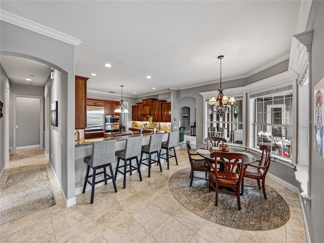 tiled dining room with ornamental molding, a textured ceiling, and a chandelier