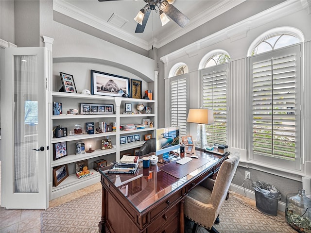 office featuring built in shelves, a ceiling fan, baseboards, visible vents, and crown molding