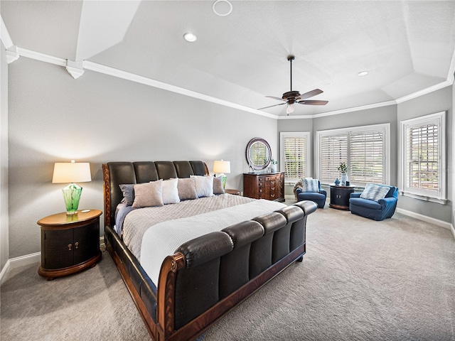 bedroom with a raised ceiling, ornamental molding, carpet floors, and ceiling fan