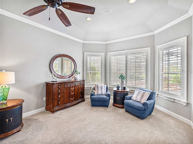 sitting room with ornamental molding, carpet, and ceiling fan