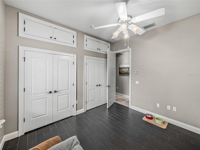 unfurnished bedroom featuring dark hardwood / wood-style floors and ceiling fan