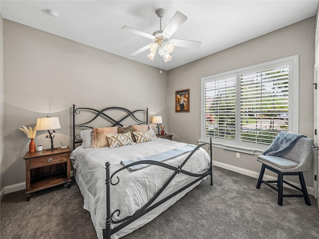 bedroom with ceiling fan and dark colored carpet