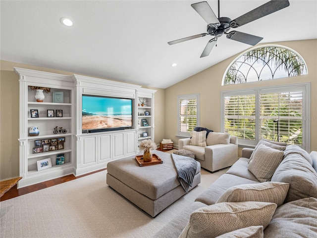 living room with ceiling fan, lofted ceiling, and light hardwood / wood-style floors