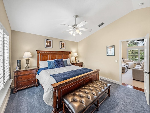 bedroom featuring ceiling fan, vaulted ceiling, and dark colored carpet