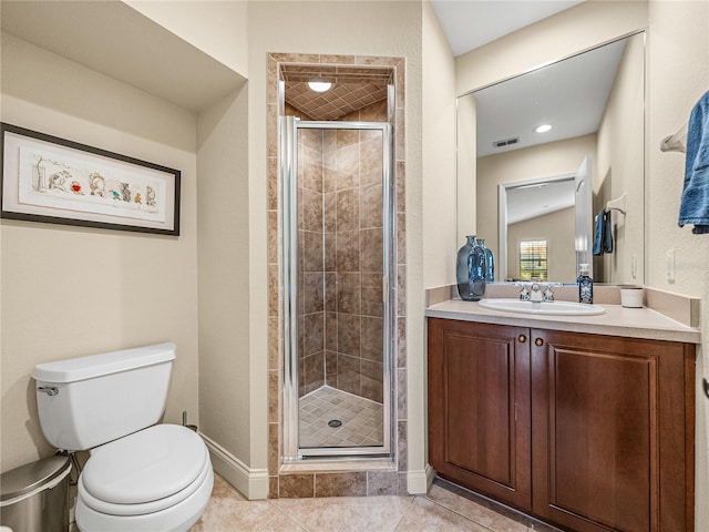 bathroom featuring tile patterned flooring, vanity, a shower with shower door, and toilet