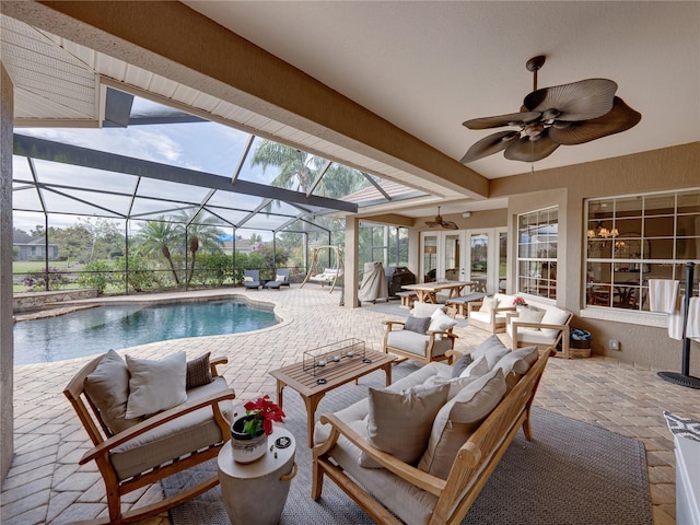 view of pool featuring an outdoor living space, a lanai, ceiling fan, and a patio area