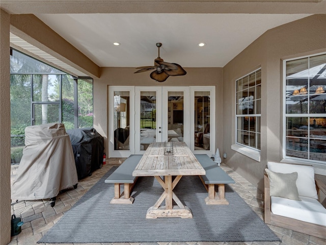 sunroom featuring french doors and ceiling fan