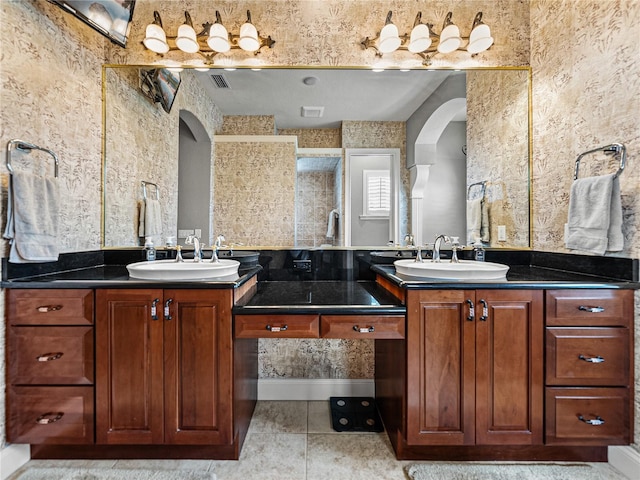 bathroom featuring vanity, tile patterned floors, and a shower with shower door