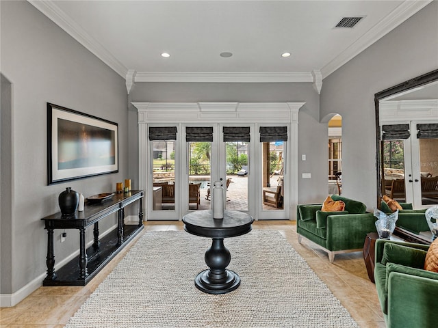 sitting room featuring arched walkways, french doors, ornamental molding, and visible vents