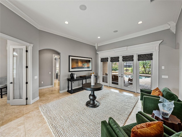 interior space featuring arched walkways, light tile patterned flooring, baseboards, french doors, and ornamental molding