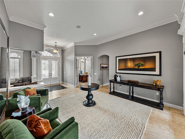 living room featuring light tile patterned floors, baseboards, crown molding, and french doors