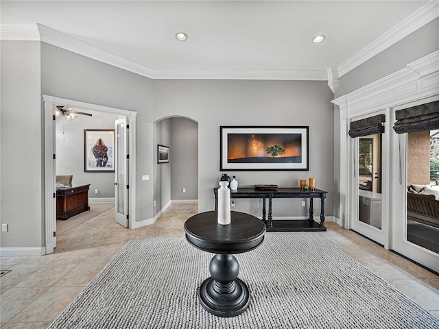 interior space with arched walkways, crown molding, and baseboards