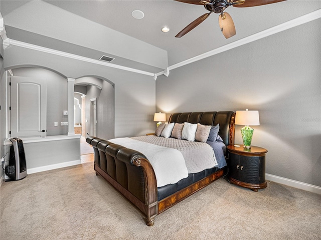 carpeted bedroom featuring arched walkways, ceiling fan, visible vents, baseboards, and crown molding