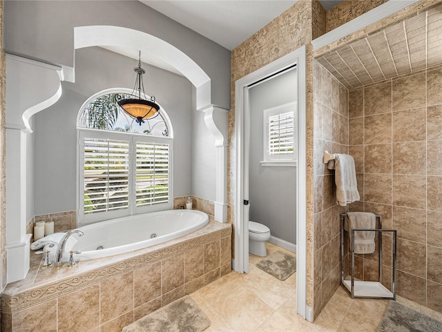 bathroom featuring a whirlpool tub, tile patterned flooring, and toilet