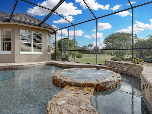 pool featuring glass enclosure, a patio, and an in ground hot tub