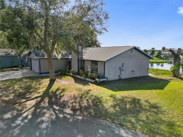 ranch-style house featuring a water view and a front yard