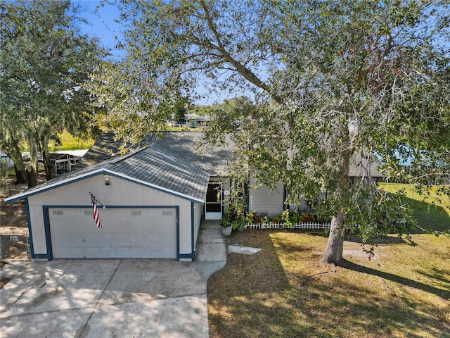 view of front of home featuring a front yard and a garage