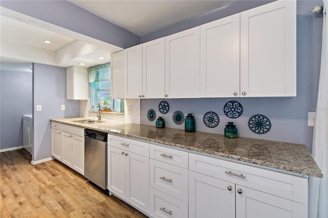 kitchen with white cabinetry, dishwasher, sink, light hardwood / wood-style flooring, and stone countertops